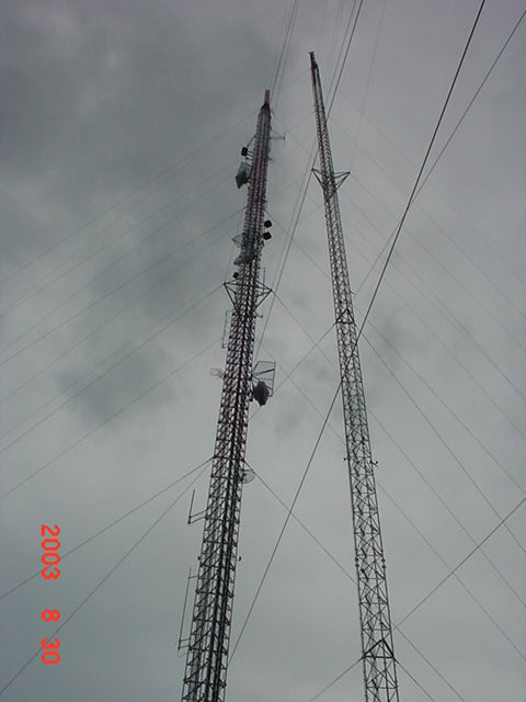 Looking Up both towers.  Old one on right stripped of antennas